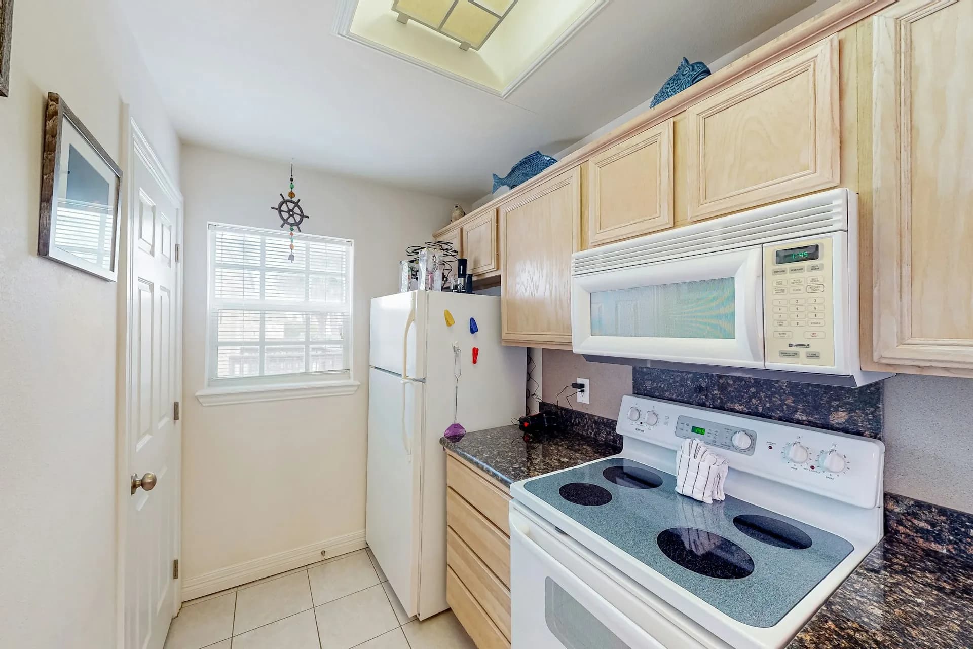 Full kitchen with stove, microwave, and refrigerator