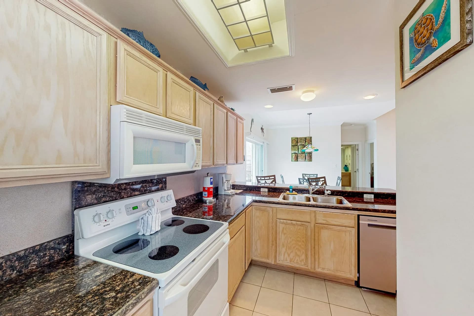 Kitchen wide view with granite countertops and dishwasher
