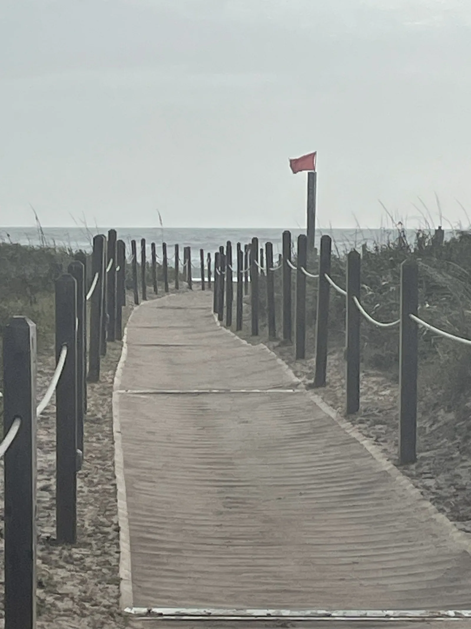 Wooden boardwalk through the dunes leading toward the Gulf of Mexico